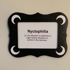 a sign on the wall that says nyctophilia is an attraction to darkness