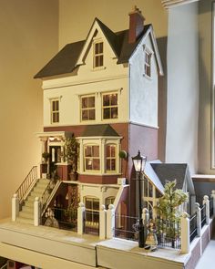 a doll house is on display in front of a window