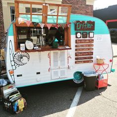 the food truck is parked on the side of the road with its door open to let people know what's inside