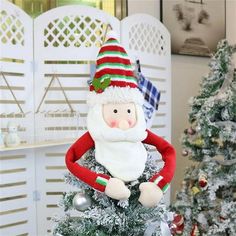 a small christmas tree with a santa clause on it's head, and other decorations