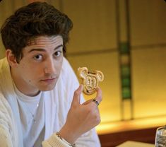 a young man holding up a piece of food