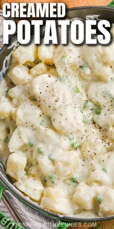 a bowl filled with creamed potatoes on top of a green table cloth next to an orange napkin