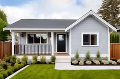 a small gray house with landscaping around it