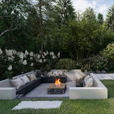 a fire pit in the middle of a lush green yard