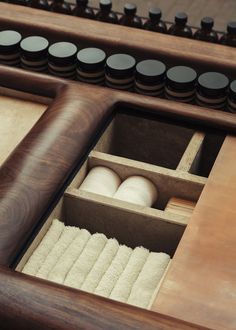 an open drawer with two rolls of thread in it