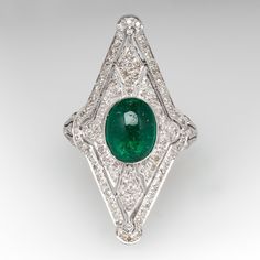 This exquisite ring features a pierced design, centered with an oval, emerald cabochon, weighing 1.75 carats, in a full bezel setting, accented with milgrain details. The top of the ring is accented with one hundred six (106) bead set, round single cut diamonds. The ring measures 31.9mm at the top, rises 8.0mm above the finger, tapering to 1.5mm wide and 0.8mm thick at the base of the shank. This ring is currently a size 5.75. The emerald has surface reaching natural inclusions. Luxury Oval Emerald Birthstone Ring, Gia Certified Oval Emerald Ring In Art Deco Style, Fine Jewelry Emerald Oval Cabochon Ring, Fine Jewelry Emerald Ring With Oval Cabochon, Green Oval Emerald Ring In Platinum, White Gold Oval Emerald Ring Art Deco Style, Emerald Oval Cabochon Ring In Fine Jewelry Style, Luxury Emerald Ring With Oval Cabochon And 17 Jewels, Luxury Oval Cabochon Emerald Ring With 17 Jewels