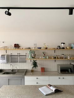 an open book sitting on top of a kitchen counter