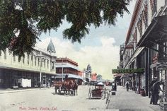 an old postcard shows horse drawn carriages on the street