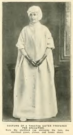 an old black and white photo of a woman wearing a priest's robe, standing in front of a window