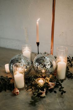 candles and disco ball decorations on the floor