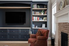 a living room filled with furniture and a flat screen tv mounted on a wall above a fireplace