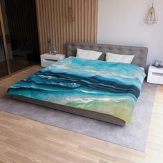 a bed with a blue and green painting on it