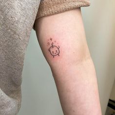 a person with a small tattoo on their arm that has a little pig in it