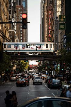 a city street filled with lots of traffic and tall buildings next to eachother