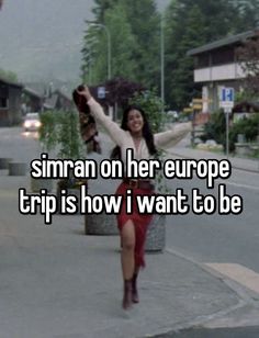 a woman is walking down the street with her arms in the air and texting,'simran on her europe trip is how i want to be