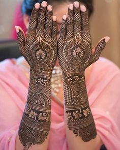 a woman with her hands covered in henna