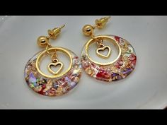 a pair of earrings sitting on top of a white plate