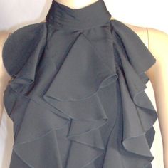 100% Polyester, Made In Vietnam. Collar 7, Bust 18, Length 25, Hip 18. Measured In Inches Laying Flat. Tops With Ruffled Collar For Night Out, Formal Black Tops With Ruffles, Night Out Tops With Ruffled Collar, Black Ruffled Tops For Formal Occasions, Formal Black Ruffled Tops, Stretch Sleeveless Ruffled Tops, Black Tops With Ruffled Collar For Summer, Black Sleeveless Top With Ruffles, Black Sleeveless Ruffled Top