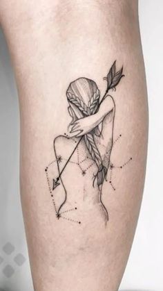 a woman with an arrow tattoo on her leg