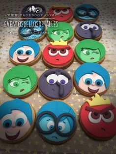 decorated cookies with cartoon characters are arranged in the shape of people's heads and eyes