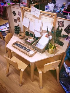 a wooden table topped with lots of cards and boxes filled with papers on top of it