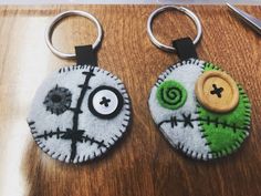 two handmade key chains with buttons on them