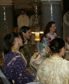 several women sitting at a table talking to each other