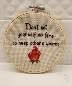 a cross - stitch pattern with words on it that says, don't set yourself on fire to keep others warm