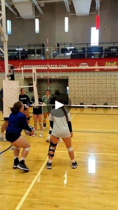 women playing volleyball in an indoor gym