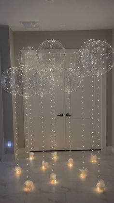 some bubbles floating in the air on top of a white floor with lights around them