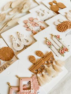 many different types of earrings are laying on the table