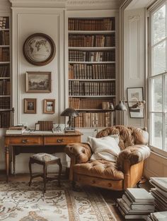 an old fashioned chair in front of a desk with bookshelves and pictures on the wall