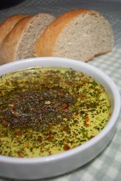 a bowl of soup with bread on the side