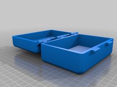 two blue plastic containers sitting on top of a gray floor next to eachother