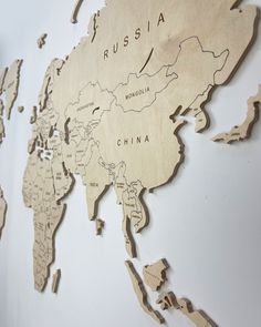 a wooden map of the world with countries