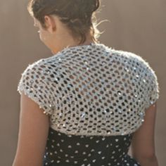 the back of a woman's dress with sequins on it