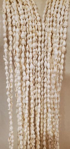 "Nassa Shell Long Lei Necklace - 2, 4 or 6-Strands of 56\"  Hawaiian Lei Necklace Set Graduation Wedding Birthday Luau Loop Lei is made with  Nassa Shells, each shell is approximately 2-4mm, around 56\" in length, strung with strong string. It comes in a set of 6 strands, you can wear it together or separated. Loop it around to wear it short, or long, style it to your liking.  Shipping from Pearl City, Hawaii 96782" White Bohemian Jewelry For Birthday, Bohemian White Jewelry For Birthday, Pearl City Hawaii, Birthday Luau, Hawaiian Lei, Long Style, Shell Necklaces, Last Minute Gifts, Lei Necklace