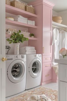 a washer and dryer in a room with pink shelving, white towels and flowers