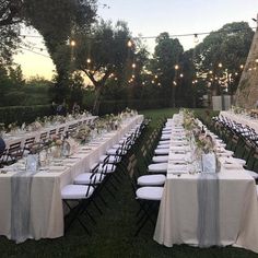 a long table set up for an outdoor dinner