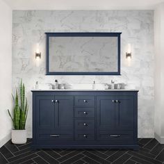 a bathroom vanity with two sinks and a mirror on the wall above it next to a potted plant