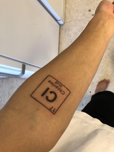 a person with a tattoo on their arm that has the number thirteen and is in front of them