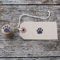 a piece of paper with a dog's paw on it next to a roll of tape