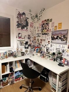 a desk with many pictures on the wall