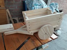 a wooden cart sitting on top of a table next to other woodworking tools and supplies