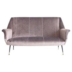 a gray couch sitting on top of a white floor