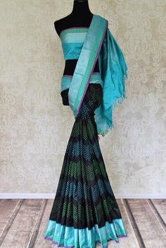 Look graceful in a black Ikat silk saree that has beautiful blue zari border and pallu. Ikat silks are one of its kind in traditional sarees. Kanchipuram Saree, Traditional Sarees, Pure Silk Sarees