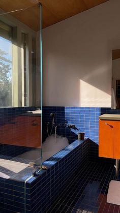 a bath tub sitting next to a window in a bathroom