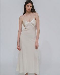 Stunning in its simplicity, the Paneled Bias Slip Dress epitomizes refined elegance. Cut in sumptuous Silk Satin, the radiant fiber drapes effortlessly throughout the silhouette—falling fluidly from the seamed bust to the ankle-length hem. Characterized by a fluid sensibility, Rosetta Getty's Silk Satin has a substantial weight that allows for durable wear. It features in bias-cut silhouettes that highlight its luxurious drape, and has an elegant feel. • V-neck • Spaghetti straps • Pulls over • Bias Slip Dress, Rosetta Getty, Layered T Shirt, Denim T Shirt, Dresses Xxl, Cape Dress, Turtle Neck Top, Sweater Skirt, Xl Dress