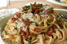 a plate of pasta with bacon and parmesan cheese