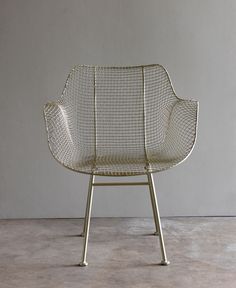 a white chair sitting on top of a cement floor